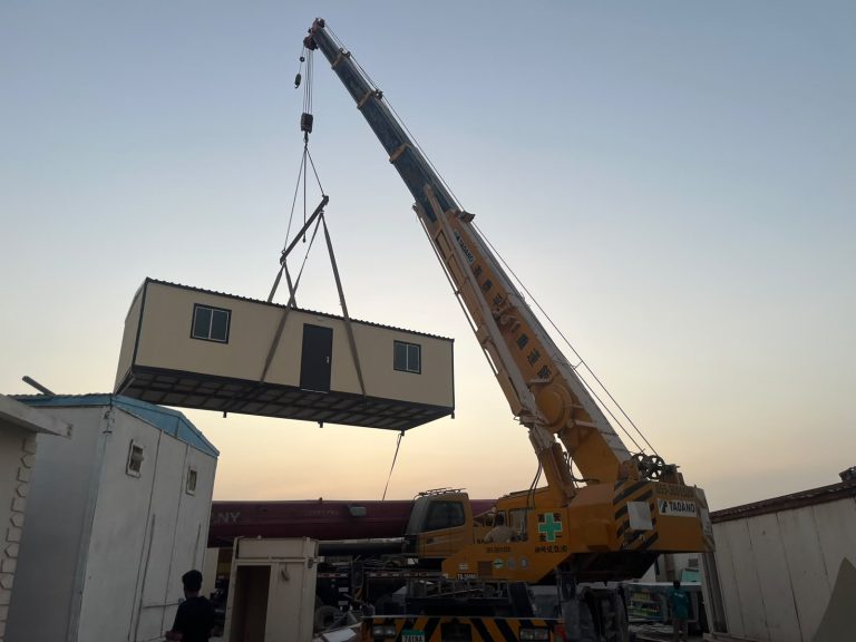 Crane repositioning a porta cabin