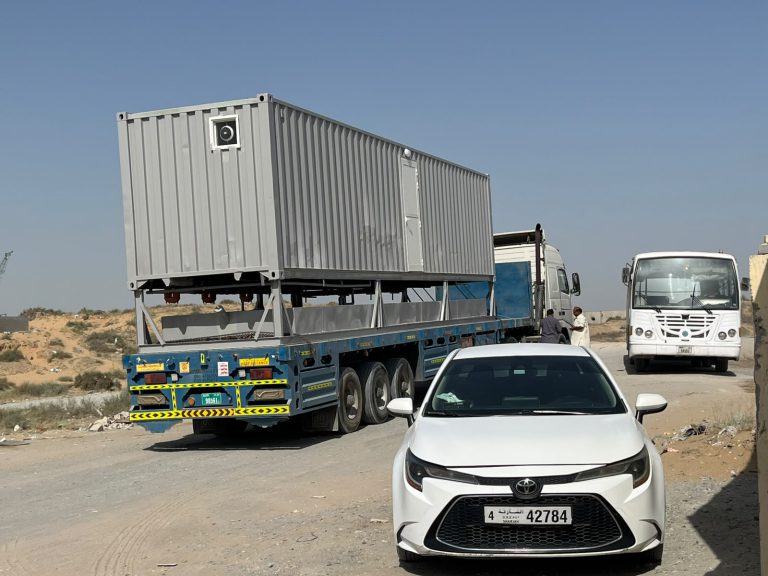 Converted container on a flatbed trailer for delivery