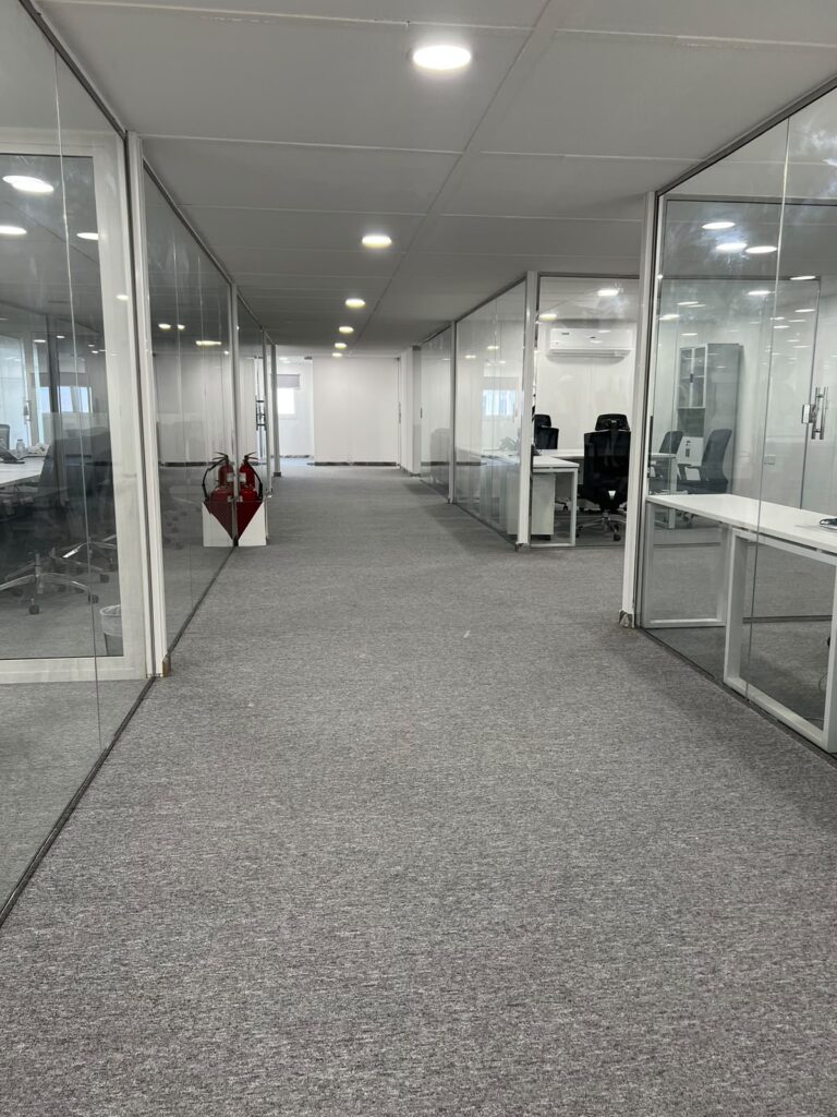 Corridor lined with glass office partitions